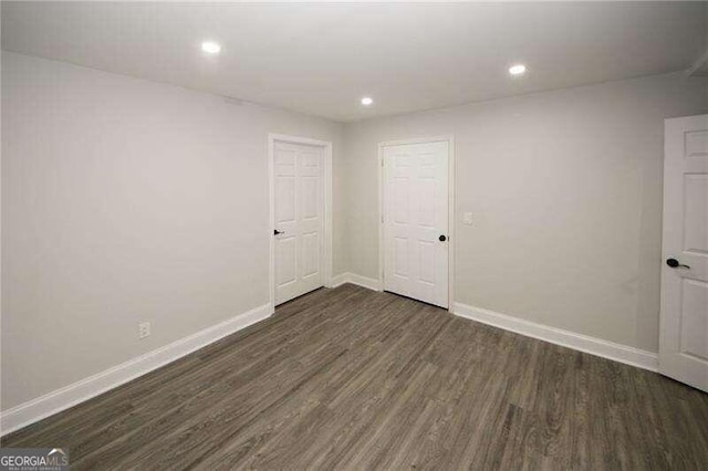 spare room featuring dark hardwood / wood-style flooring