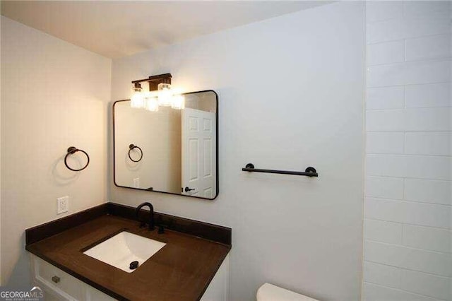 bathroom featuring vanity and toilet