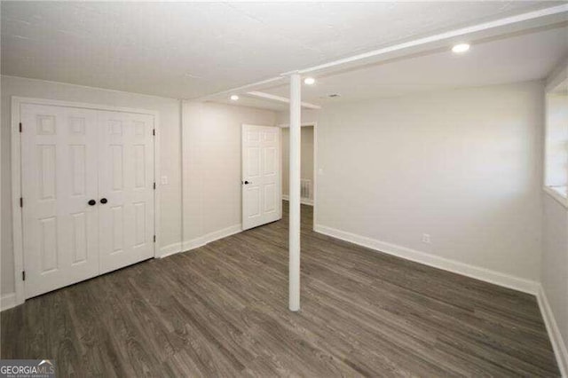 basement with dark wood-type flooring