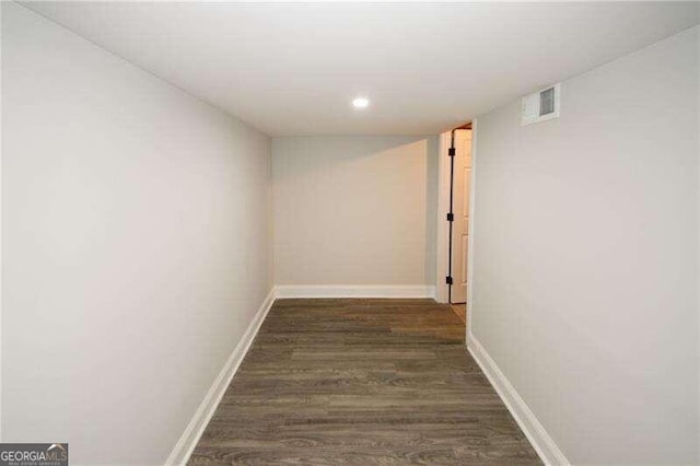 corridor featuring dark hardwood / wood-style flooring