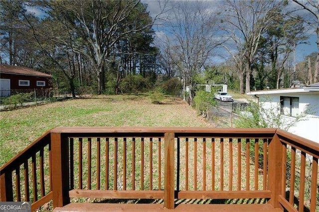 wooden deck with a lawn