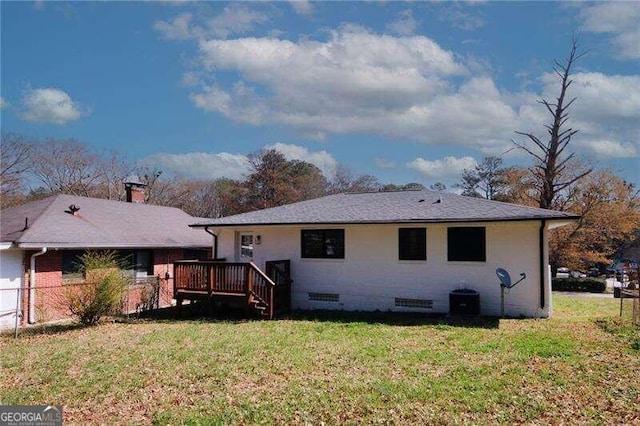 back of property featuring a yard and a wooden deck