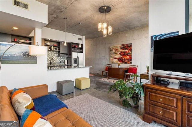 living room with sink and a chandelier