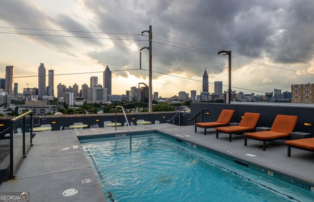 view of pool at dusk