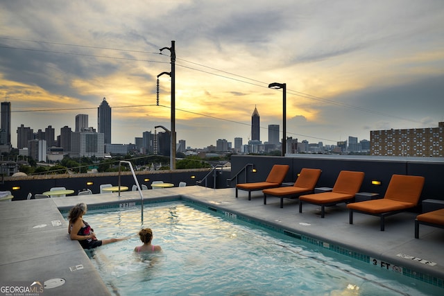 view of pool at dusk