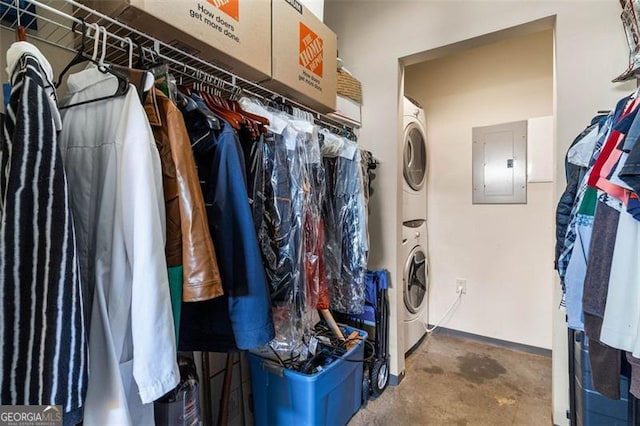 walk in closet with stacked washer and clothes dryer and electric panel