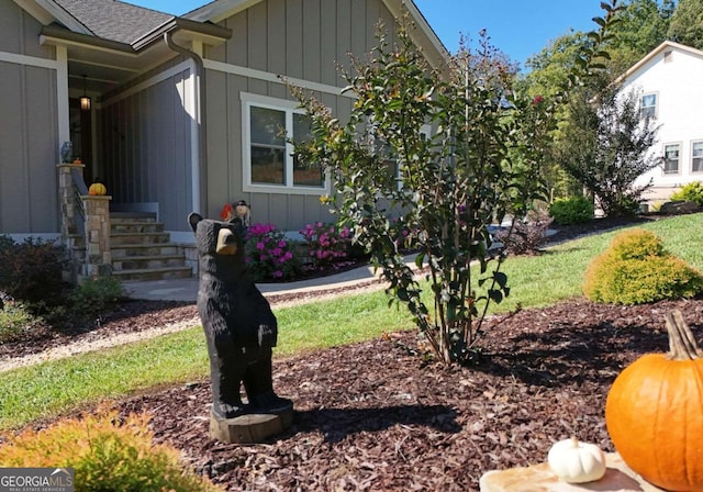 view of side of home with a yard