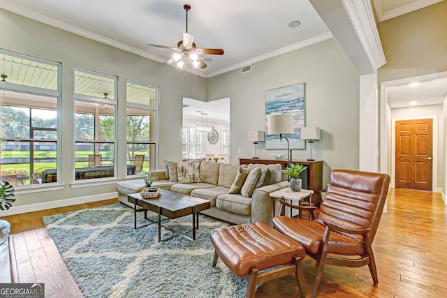 living room featuring ceiling fan, ornamental molding, and light hardwood / wood-style floors