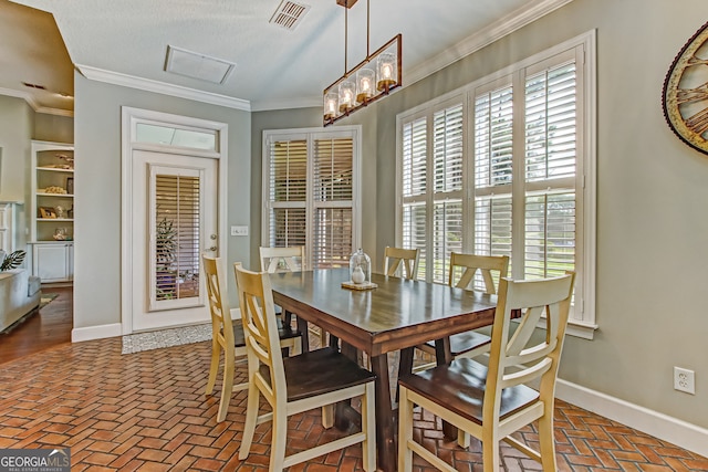 dining space featuring ornamental molding and a textured ceiling