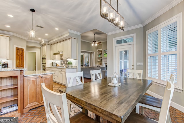 dining area with ceiling fan and ornamental molding