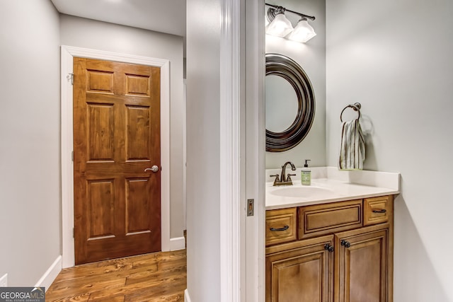 bathroom featuring hardwood / wood-style flooring and vanity