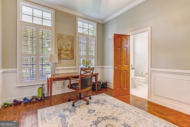 office space featuring wood-type flooring and crown molding