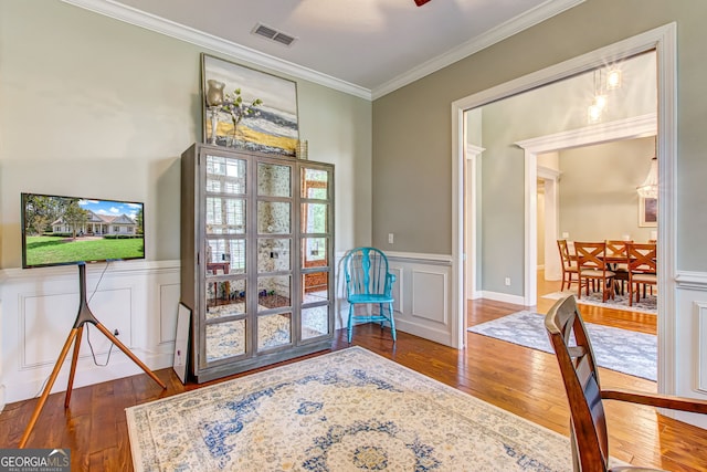 doorway to outside with ornamental molding and dark hardwood / wood-style flooring