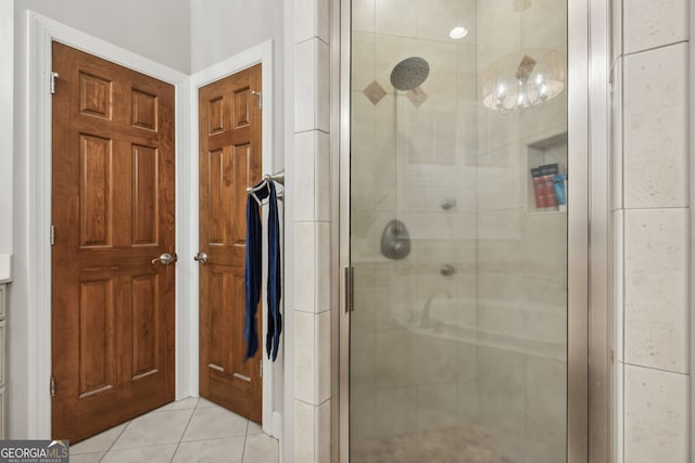 bathroom with tile patterned flooring and a shower with door