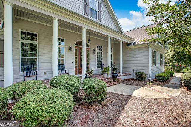 view of exterior entry with covered porch