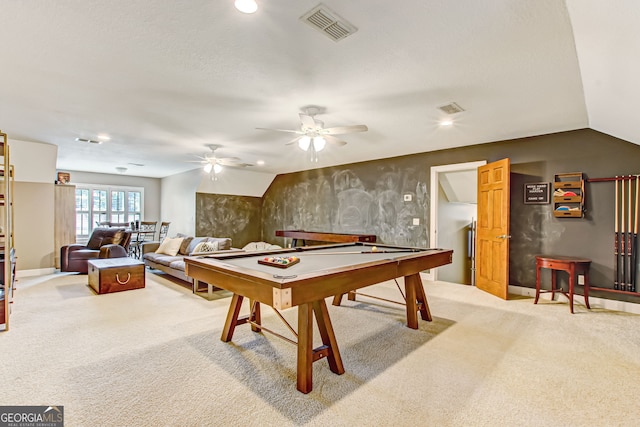 recreation room featuring ceiling fan, vaulted ceiling, and light colored carpet