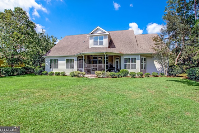 view of front of property featuring a sunroom and a front lawn