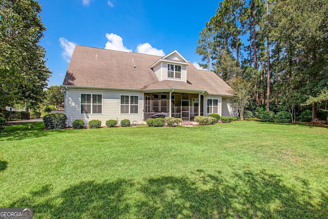 back of property featuring a sunroom and a yard