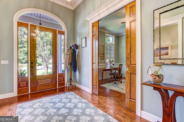 entryway featuring ornamental molding and hardwood / wood-style flooring