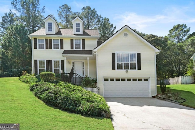 view of front of home with a garage and a front lawn