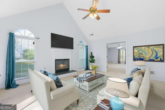 living room with light carpet, high vaulted ceiling, and ceiling fan