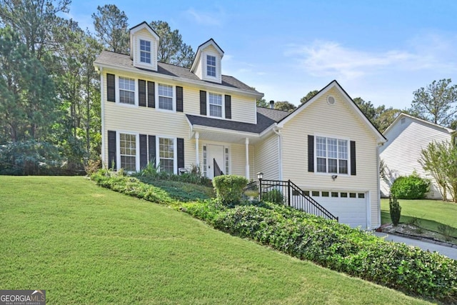 view of front of house featuring a front lawn and a garage