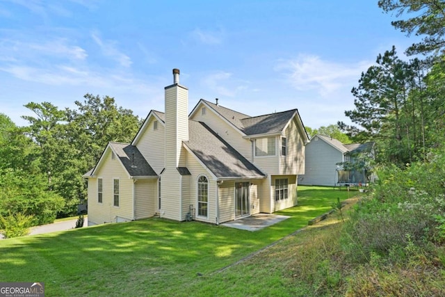 back of property with a patio and a lawn