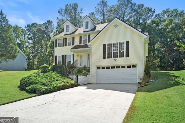 view of front of property with a garage and a front lawn