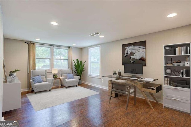 office featuring wood finished floors, visible vents, and baseboards