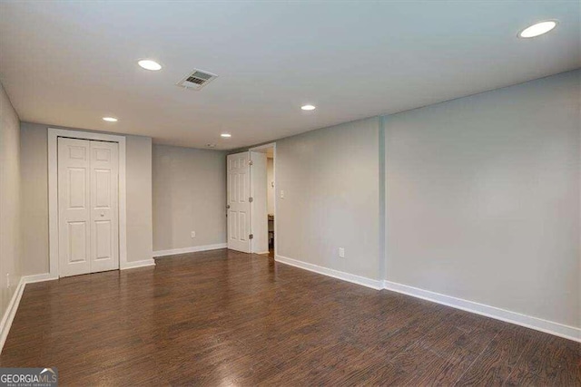 empty room with recessed lighting, visible vents, wood finished floors, and baseboards