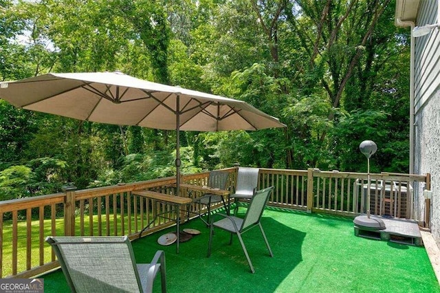 wooden deck featuring a yard