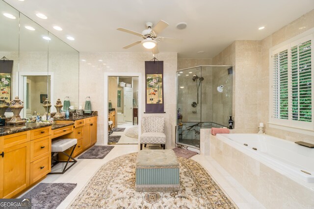 bathroom with ceiling fan, plus walk in shower, tile patterned floors, vanity, and tile walls