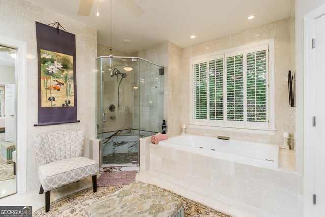 bathroom featuring ceiling fan and shower with separate bathtub