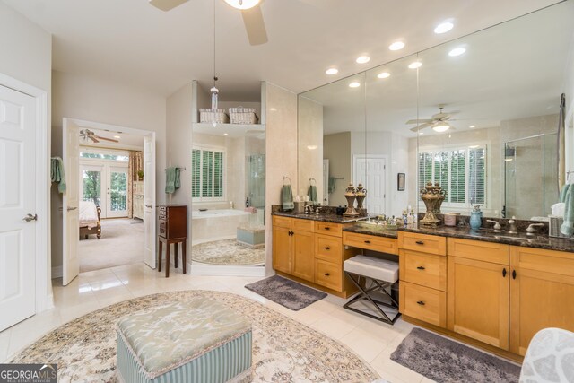 bathroom with ceiling fan, french doors, plus walk in shower, tile patterned floors, and vanity