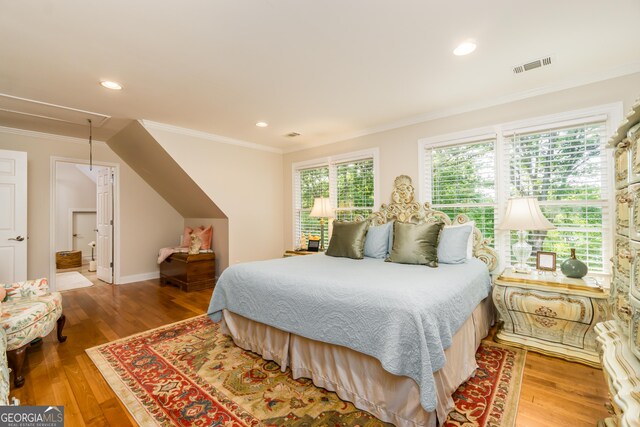 bedroom featuring multiple windows, crown molding, and hardwood / wood-style floors