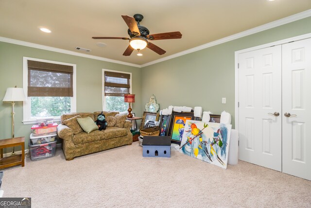 recreation room featuring carpet, ceiling fan, and ornamental molding