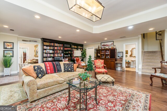 living room with crown molding and hardwood / wood-style floors