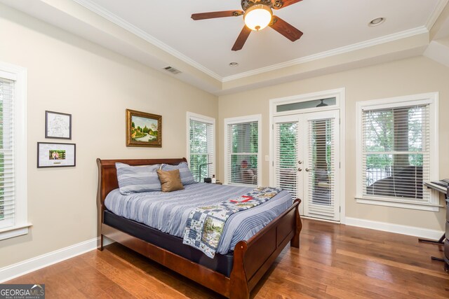 bedroom featuring dark hardwood / wood-style flooring, access to outside, multiple windows, and ceiling fan