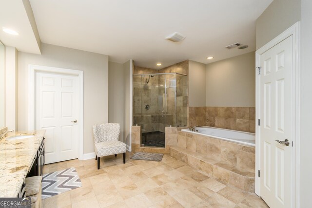 bathroom featuring vanity and independent shower and bath