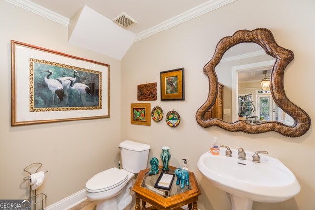 bathroom with crown molding, sink, and toilet