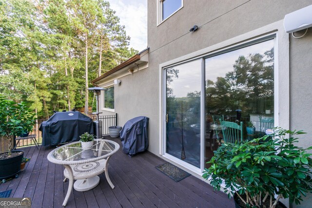 wooden deck featuring area for grilling