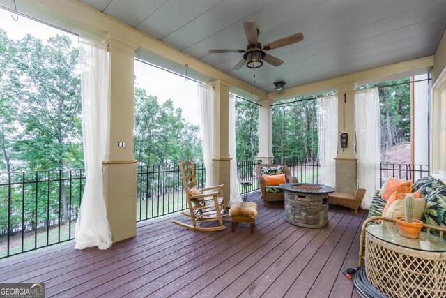 sunroom featuring ceiling fan