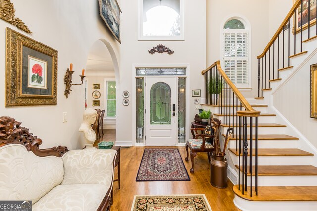 entryway with a high ceiling and hardwood / wood-style flooring