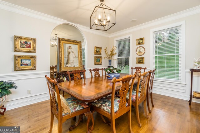 dining space with crown molding and hardwood / wood-style flooring