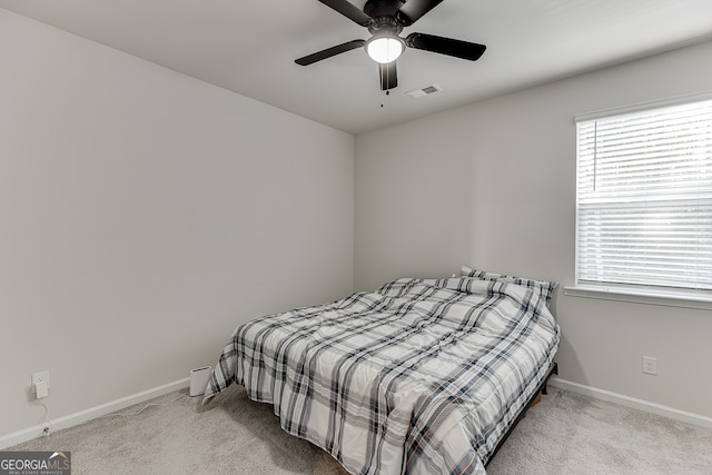 bedroom featuring ceiling fan and light carpet