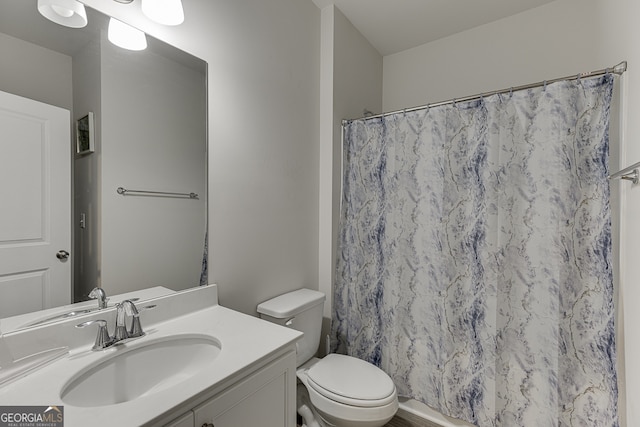 bathroom with vanity, toilet, and curtained shower