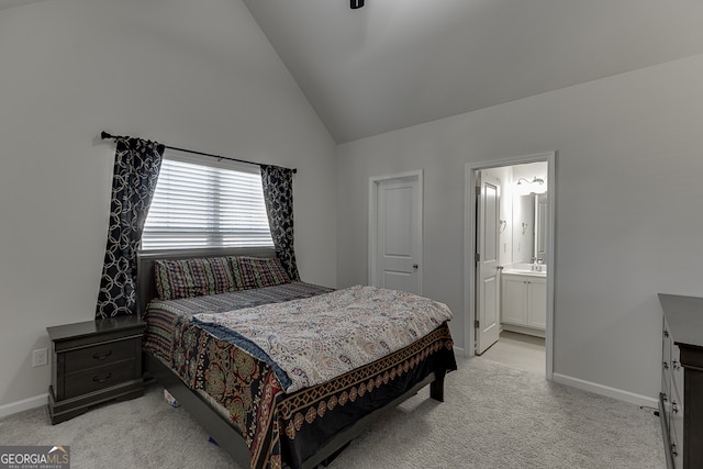 bedroom featuring light colored carpet, sink, ensuite bathroom, and high vaulted ceiling