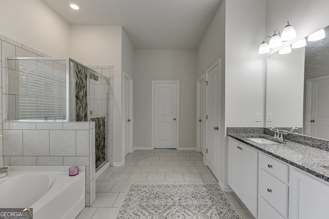 bathroom featuring vanity, separate shower and tub, and tile patterned floors