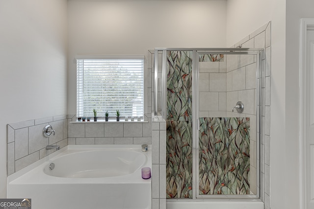 bathroom featuring shower with separate bathtub