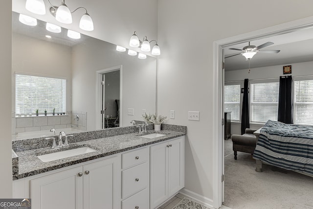 bathroom featuring ceiling fan, vanity, and a wealth of natural light